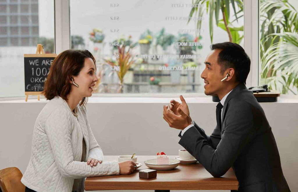 two people use w4 translation earbuds to communicate